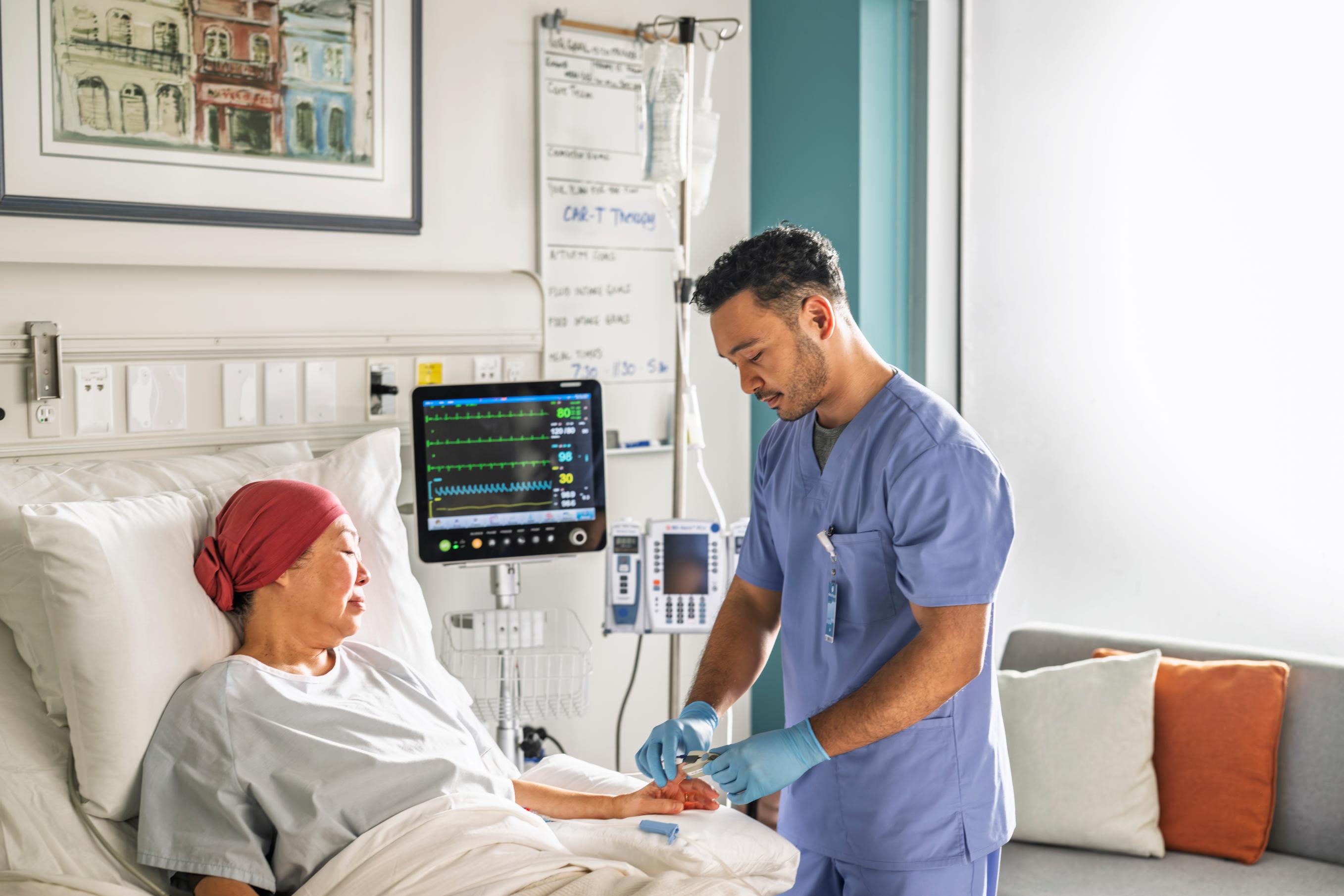 An Advanced Practice Provider caring for a patient in a hospital room.